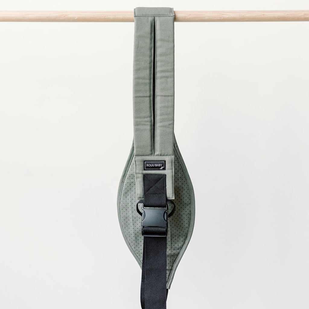 Baby seated in the Olive Rouu Baby II ergonomic hip carrier