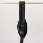 Jet Black Rouu Baby II hip carrier worn on the hip, side view