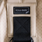 Baby seated in the Sand Beige Rouu Baby II ergonomic hip carrier